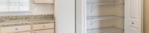 a kitchen with white cabinets and an open refrigerator