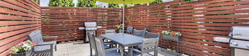 a patio with a table and chairs and an umbrella