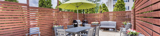 the patio has a table and chairs and an umbrella on it