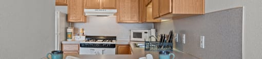 A kitchen with a table set for two.