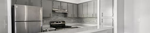a kitchen with stainless steel appliances and a white counter top