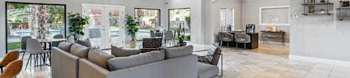 a living room with couches and a table with chairs