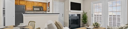 a living room with a couch a chair a table and a fireplace