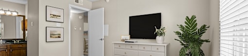 a bedroom with a large bed and a ceiling fan