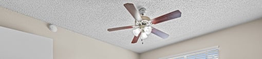 a bedroom with a large bed and a ceiling fan