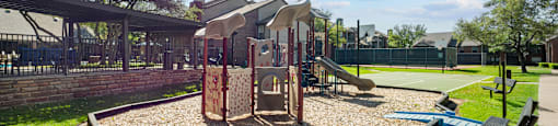 A playground with a sandbox and a slide.
