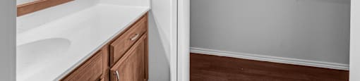 A bathroom with a white counter top and a white sink.