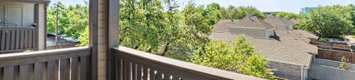A balcony with a view of a residential area.