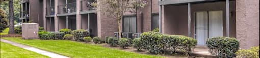 Exterior at Barrington Park Apartments with a green lush courtyard.