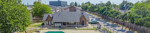 A residential area with a swimming pool and a fenced yard.