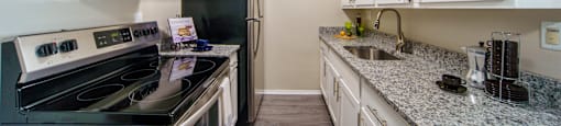 Updated white and grey kitchen with stainless steal appliances.