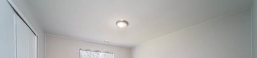 bedroom with white walls and window