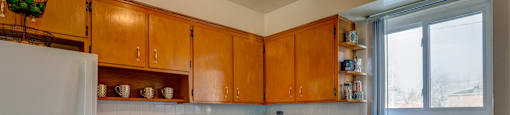 A kitchen with wooden cabinets and a white refrigerator.