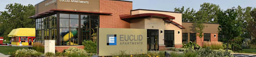 The front of a building with the name Euclid Apartments on it.