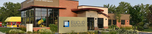 The front of a building with the name Euclid Apartments on it.