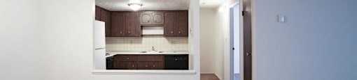 Living area overlooking hallway and kitchen with ceiling fans
