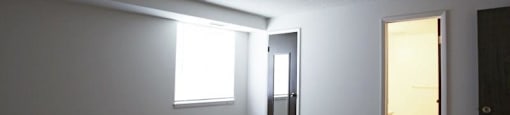 Bedroom with carpeting and door leading to bathroom