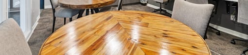 A conference room with a wooden table and chairs.
