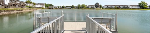 A bridge over a body of water with a clear blue sky above.