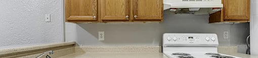 A kitchen with a white oven and a white dishwasher.