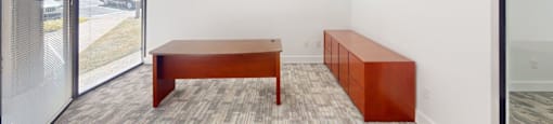 A room with a long table and a bench.