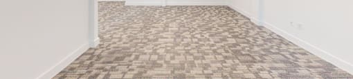 A room with a carpeted floor and white walls.