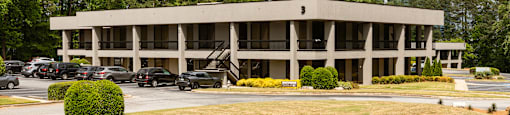 A large building with a parking lot in front of it.