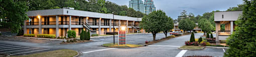 A large building with a parking lot in front of it.