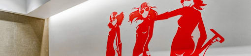 A wall with a red graphic of two women.