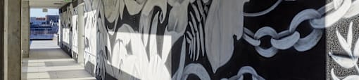 A long hallway with a black and white mural on the wall.