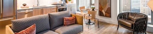 A modern living room with a grey sofa and a wooden coffee table.