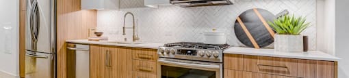 A modern kitchen with wooden cabinets and stainless steel appliances.