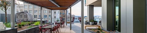 A modern building with a patio and a bench.