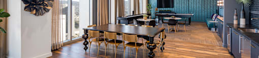 A modern dining room with a wooden table and chairs.