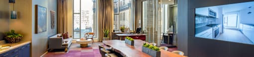 A conference room with a long table and chairs.