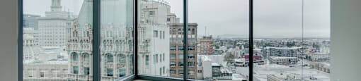 A large empty room with a view of the city.