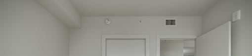 A white door is in a room with wood flooring.