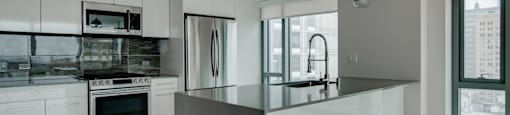 A modern kitchen with a large island in the center.