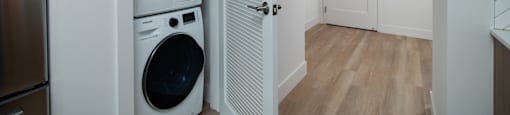 A laundry room with a washer and dryer stacked on top of each other.