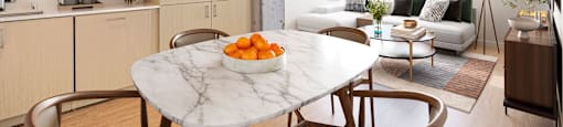 A modern kitchen with a marble table and chairs.