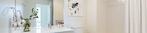 A white bathroom with a toilet, sink, and bathtub.