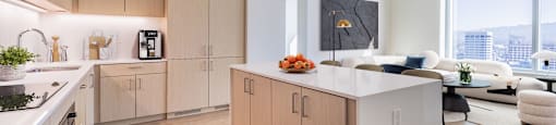 A modern kitchen with wooden cabinets and a white island.