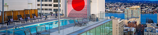 A modern building with a pool and a red circle on the side.