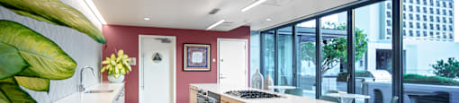 A kitchen with wooden floors and white countertops.