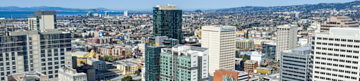 A cityscape with various buildings and a clear sky.