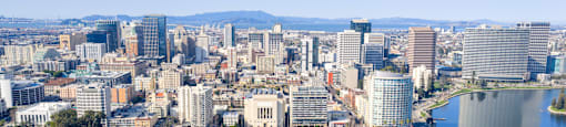 A cityscape with a large body of water in the foreground.