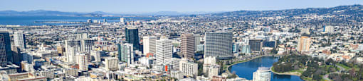 A cityscape with a large body of water in the foreground.