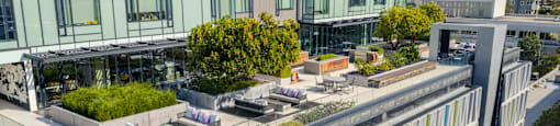 A modern building with a green roof and a glass facade.