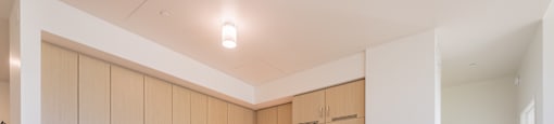 A kitchen with wooden cabinets and a white island.
