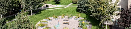 Aerial view of a courtyard with trees and community garden beds at Mullan Reserve Apartments in Missoula, MT